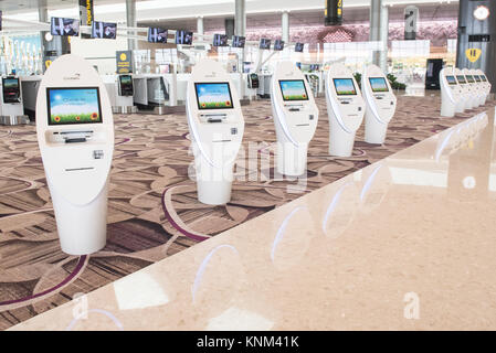 A row of self service check in counter at Singapore Changi Airport Terminal 4, using technology assisted methods Stock Photo