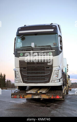 FORSSA, FINLAND - DECEMBER 20, 2014: New Volvo FH trucks are transported on a low floor semi trailer. Volvo is the market leader by in Finnish first t Stock Photo