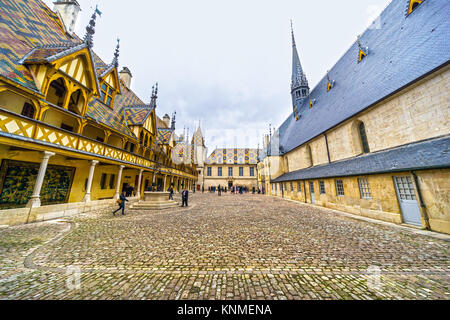 BEAUNE, FRANCE - NOVEMBER 18, 2017: The Hospices of Beaune courtyard with visitors, in Beaune, Burgundy, France Stock Photo