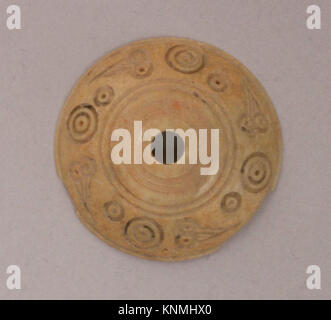 Decorative button or bead in ceramic or glass, reflecting historical techniques and material use. Part of The Metropolitan Museum of Art collection. Stock Photo
