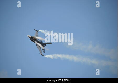 Lockheed Martin General Dynamics f-16 fighting falcon from Belgium during an airshow with condensation going over the inner part of the wings. Stock Photo