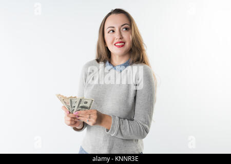 oung woman holding dollars cash and happy smiling isolated Stock Photo