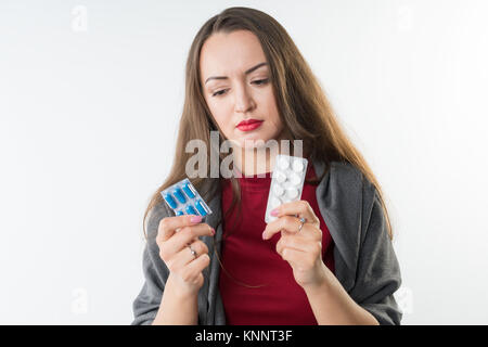 Woman holds two types of drugs Stock Photo