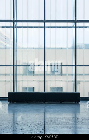 Indoor Rectangular Bench In front of Glass Wall Cold Blue Atmosphere Art Gallery Quiet Room Alone Stock Photo
