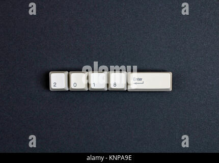 2018 year enter written using the white keyboard keys on a dark background Stock Photo