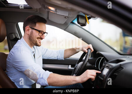 Man using navigation system while driving car Stock Photo