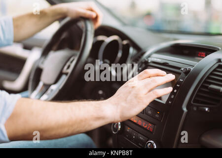 Man using navigation system while driving car Stock Photo