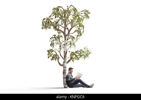 Young man reading a newspaper under a birch tree isolated on white background Stock Photo