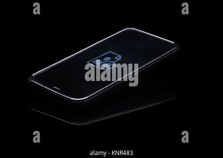 Online data security. Smartphone isolated on blak background with disk and lock icon on screen. Stock Photo