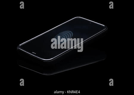 Fingerprint identification on cellphone. Smartphone isolated on blak background with fingerprint icon on screen. Stock Photo