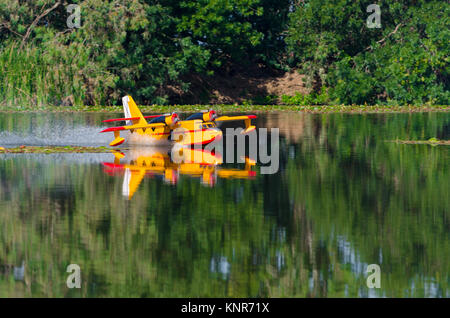 A floating Radio controlled model hydroplane speeds up to take off on Guadiana river, Badajoz Stock Photo