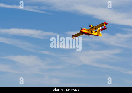 Radio controlled model hydroplane flying over blue sky Stock Photo