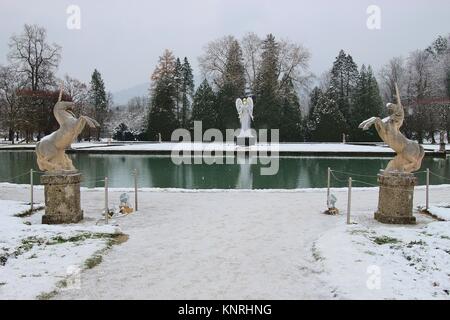 In the baroque park of Hellbrunn Palace, in winter. Two unicorn sculptures and a Christmas angel installation. Salzburg city, Austria, Europe. Stock Photo