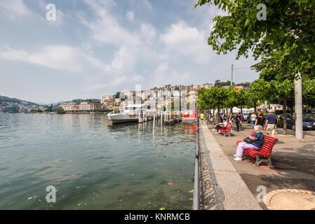 Lugano, Switzerland - May 28, 2016: People rest on the Embankmen of Lake Lugano, Lugano, Switzerland, Europe. Stock Photo