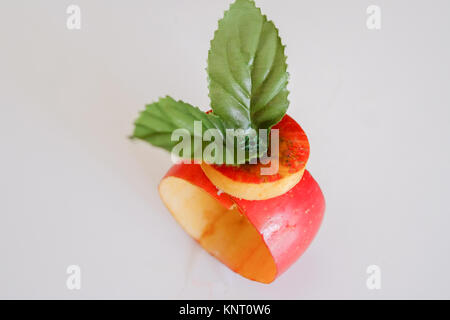 Fake fruit smartwatch bracelet with red apple. Studio shot Stock Photo