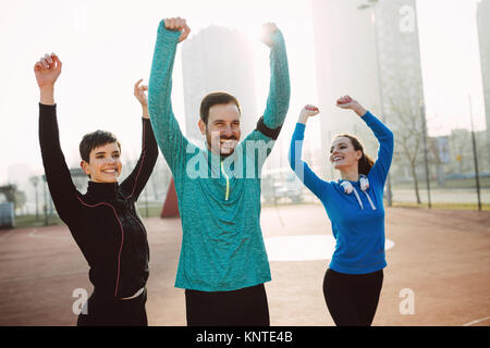 Determined group of friends satisfied and happy after achieving  Stock Photo