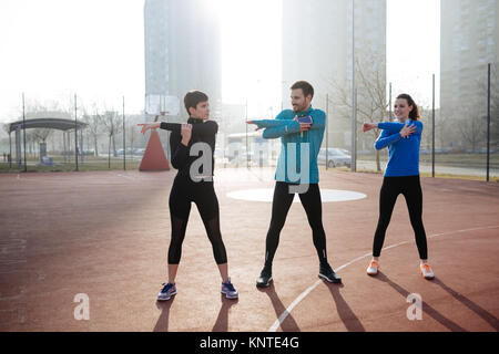 Group of healthy sporty determined friends fitness training toge Stock Photo