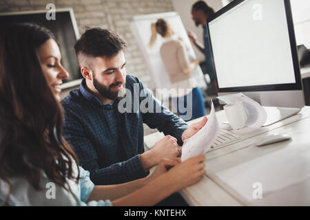 Happy creative coworkers working in designer office Stock Photo