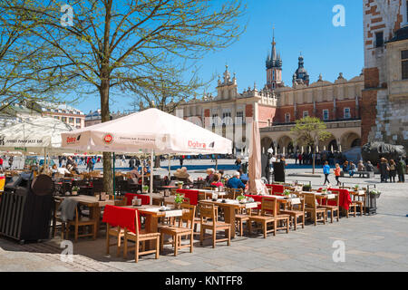 Market Square Krakow, a cafe terrace sited on the west side of Market Square (Rynek Glowny) facing the medieval Cloth Hall in Krakow old town, Poland. Stock Photo