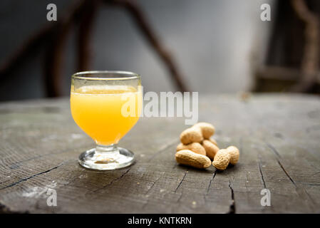 A glass of Poncha and a handful of peanuts at Taberna da Poncha in Madeira Stock Photo
