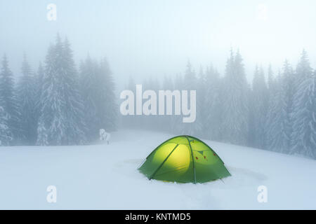 Green tent lighted from the inside Stock Photo