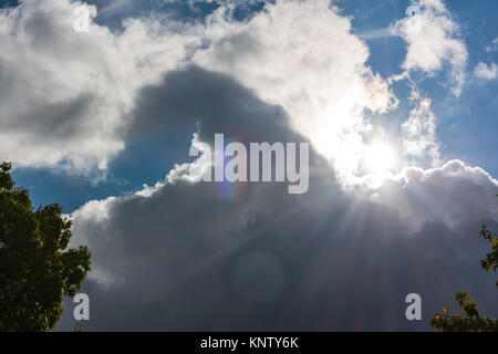 Sun Flare Coming from Behind Clouds Rays Contrast Dark Blue Sky Daytime Stock Photo