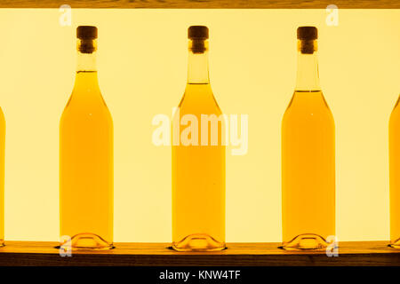 Abstract Yellow Clear Glass Bottles Shelf Backlit Stock Photo
