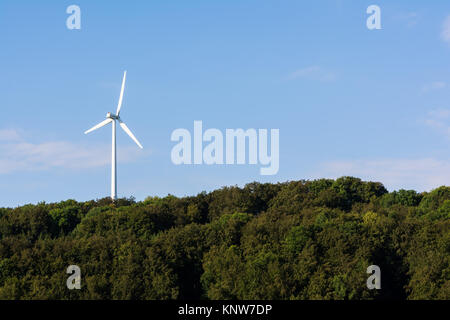 Windmill Turbine Forest Hilltop on Clear Day Stock Photo