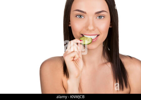 woman biting slice of cucumber Stock Photo