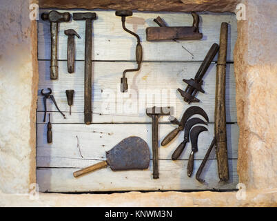 Old tools collection on wooden wall. Abstract photo. Stock Photo