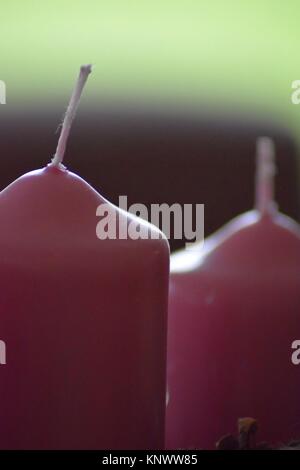 two candles in christmas time with a moody background Stock Photo