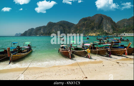 Tonsai Beach bay view with many traditional longtail boats parking and palm seafront in Thailand, Phi Phi island, Krabi Province, Andaman Sea Stock Photo