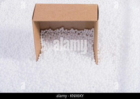 Box on little  white polystyrene foam balls Stock Photo