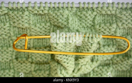 Basket Weave Pattern Knitted On Knitting Needles In Sage Green Color Wool. Stitch  Holder In Place Marking Off Extra Stitches To Be Knit Later Stock Photo,  Picture and Royalty Free Image. Image