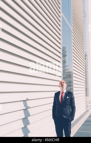 middle age contemporary business man outdoors posing looking away - business, attitude, elegant concept Stock Photo