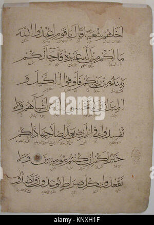 This folio from a Qur'an manuscript displays Arabic calligraphy and ...