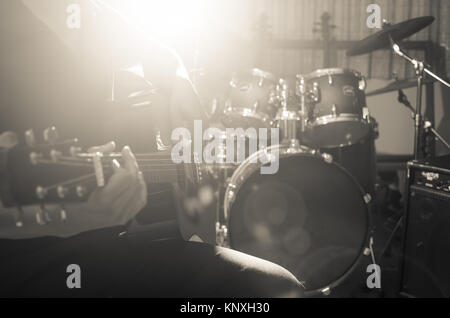 Closeup musician playing the guitar on band background with spot light, musical concept Stock Photo