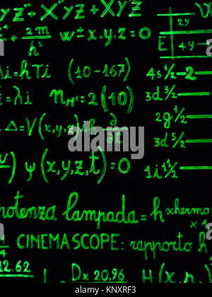 mathematical calculations written with a green marker on a black background. Stock Photo