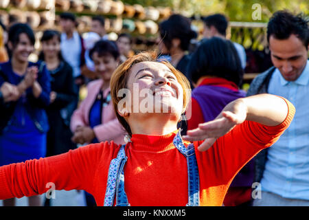 A Young Uzbek Woman Dancing In The Street, Khiva, Uzbekistan Stock Photo