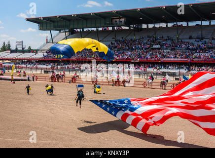 CHEYENNE, WYOMING, USA - JULY 27, 2017: US Navy Leap Frogs team of skydivers opens the annual Frontier Days Rodeo. Carrying the American flag. Stock Photo