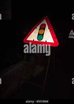 traffic light sign at night triangle red amber green construction; essex; england; uk Stock Photo
