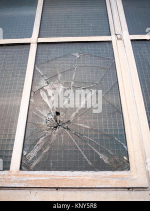 smashed broken window up close criminal damage vandalism crime; essex; england; uk Stock Photo