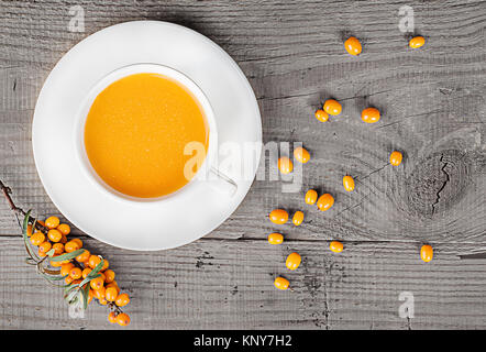 Sea buckthorn juice on a wooden table Stock Photo