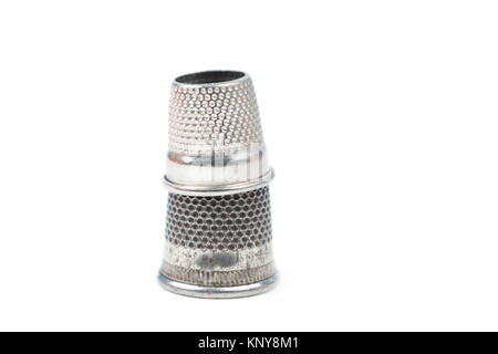 Two metal silver sewing thimbles on a white background. Sewing accessories and tools Stock Photo