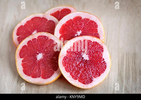 On the table cut fruit grapefruit. Presents closeup. The view from the top. Stock Photo