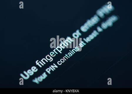 New york, USA - December 12, 2017: Unlocking phone with fingerprint or entering PIN code on smartphone screen close-up Stock Photo