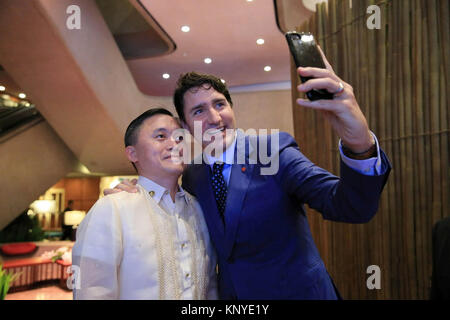 Special Assistant to the President Christopher Lawrence Go, left, poses for a selfie with Canada Prime Minister Justin Trudeau on the sidelines of the ASEAN Summit at the Philippine International Convention Center November 14, 2017 in Pasay City, Manila, Philippines. Stock Photo