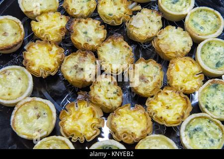 baking mini bite size quiche appetizers Stock Photo