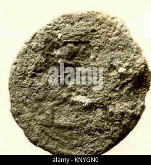 An ancient coin showing detailed inscriptions, imagery, and metal ...