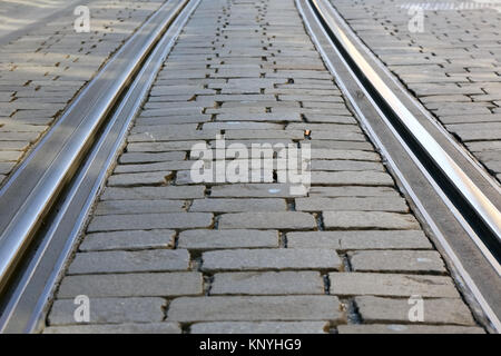 The tram rails on the paved street surface are visible in Bern, Switzerland Stock Photo